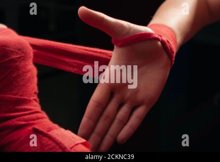 Boxer girl in red boxing bands close-up. Stock Photo