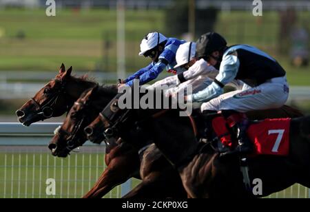 Dublin Pharaoh ridden by jockey William Buick (left) wins the Tellisford Handicap race with Zambezi Magic ridden by jockey Hector Crouch second and Topanticipation ridden by jockey Shane Kelly third at Sandown Racecourse Surrey. Stock Photo