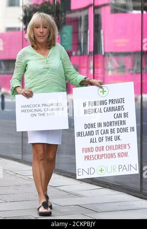 Elaine Levy outside the offices of the Department of Health & Social Care in London. Ms Levy is one of five parents who held a vigil at health authority buildings in England, Scotland and Wales on Wednesday, in protest against being denied NHS prescriptions despite medical cannabis being legalised in 2018. Stock Photo