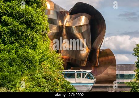 Seattle monorail in front of Frank Gehry designed EMP Museum at the Seattle Centre. Stock Photo