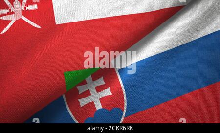 Oman and Slovakia two flags textile cloth, fabric texture Stock Photo