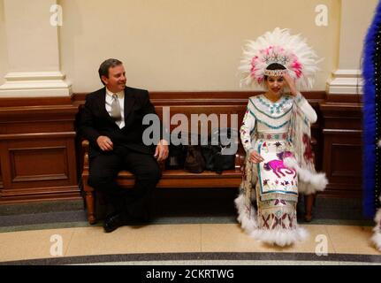 Austin, TX January 25, 2009: Teen girl dressed in Princess Pocahontas costume sits on the floor of the Texas House of Representatives to promote the 112th- annual George Washington's Birthday celebration in the border towns of Laredo and Nuevo Laredo, Mexico. ©Bob Daemmrich Stock Photo