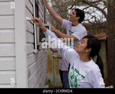 Austin, TX February 14, 2009: University of Texas at Austin students, including members of the Filipino-American Students Assn., work on sprucing up houses and public areas in east Austin as part of the second annual Clinton Global Initiative University, a conference bringing together students to take action on global challenges such as poverty, hunger, energy, climate change and global health. The program is patterned after Clinton Global Initiative Foundation formed by President Bill Clinton. ©Bob Daemmrich Stock Photo