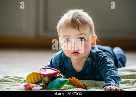 6-10 month old baby playing on his belly Stock Photo