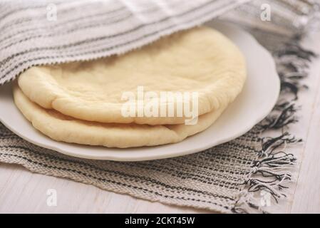 Closeup of uncooked flatbread on plate Stock Photo