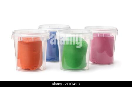 Group of plastic containers with colorful modeling clay isolated on white Stock Photo