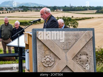 David Stillie giving a speech at the Battle of Pinkie Cleugh commemoration ceremony with the memorial, East Lothian, Scotland, UK Stock Photo