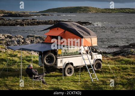 Clifden Ireland July 25 2020 A Man Camping On The West Coast Of Ireland In A Land Rover With A Roof Tent Stock Photo Alamy
