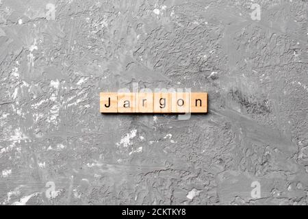 Jargon word written on wood block. Jargon text on cement table for your desing, Top view concept. Stock Photo