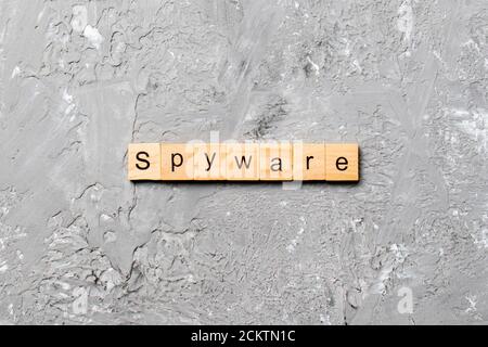 spyware word written on wood block. spyware text on cement table for your desing, concept. Stock Photo