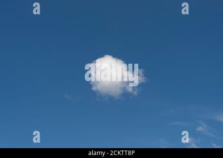 Single white cloud on a clear blue sky Stock Photo