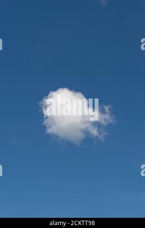 Single white cloud on a clear blue sky Stock Photo