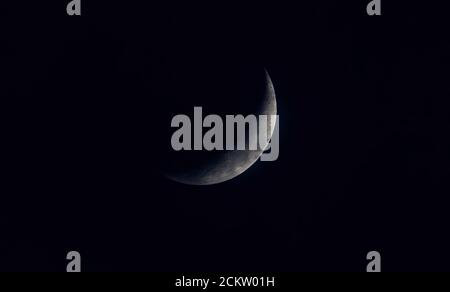 Sickle shaped moon on the night sky Stock Photo