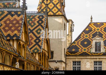 Roofs with colorful glazed tiles of the Hotel-Dieu, Hospices de Beaune, France Stock Photo