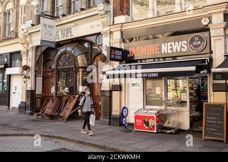 London, Britain. 16th Sep, 2020. A man wearing a face mask walks past a closed pub in London, Britain, on Sept. 16, 2020. The UK's unemployment rate rose to 4.1 percent in the three months to July, with young people the hardest hit, the country's Office for National Statistics (ONS) said Tuesday. Credit: Tim Ireland/Xinhua/Alamy Live News Stock Photo