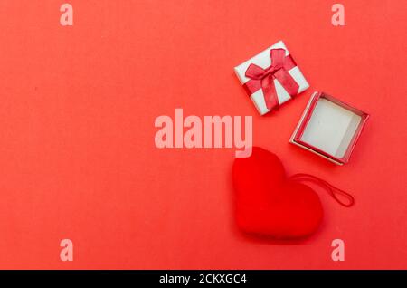 Empty open ring box and heart on red background. concept of the holiday, Valentine's Day Stock Photo