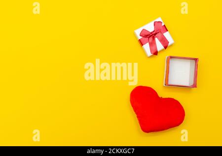 Empty open ring box and heart on yellow background. concept of the holiday, Valentine's Day Stock Photo