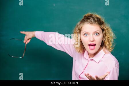School rules. School principal stressful outraged expression. Educational system concept. School lesson knowledge. Remember this. Strict woman teacher pointing at chalkboard. Informing kids. Stock Photo