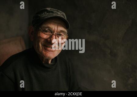 Pensive old man in glasses with gray hair Stock Photo