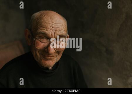 Pensive old man in glasses with gray hair Stock Photo