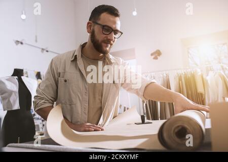 Seamstress works to new clothes ordered by internet client Stock Photo