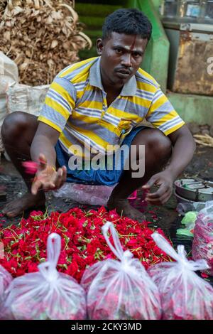 A local flower seller in a flower market near Madurai, Tamil Nadu, India Stock Photo