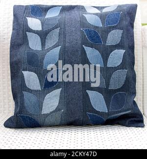 Home made recycled jeans pillow with leaves Stock Photo