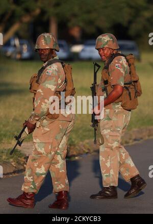 South African National Defence Force Sandf Soldier Watches As Deputy President Thabo Mbeki Arrives At Indala High School In Richmond May 9 Mbeki Has Been Campaigning In Kwazulu Natal Province Since Last