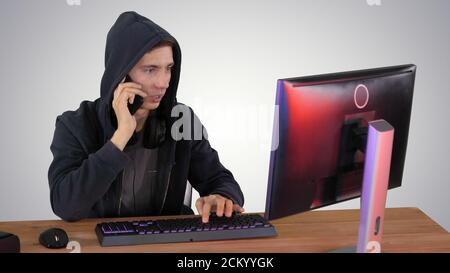 Experienced hacker answers someones call on gradient background. Stock Photo