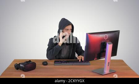 Experienced hacker answers someones call on gradient background. Stock Photo
