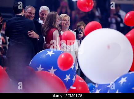 Democratic presidential nominee Hillary Clinton enjoys the balloon drop with her husband former president Bill Clinton and daughter Chelsea Clinton after she accepted the nomination on the fourth and final night at the Democratic National Convention in Philadelphia, Pennsylvania, U.S. July 28, 2016. REUTERS/Lucy Nicholson