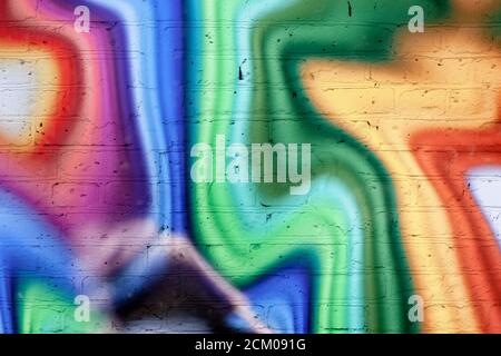 Colored rainbow in curved lines and zigzags. Multi-colored brick wall. Banner bright background. Abstract graffiti. Stock Photo