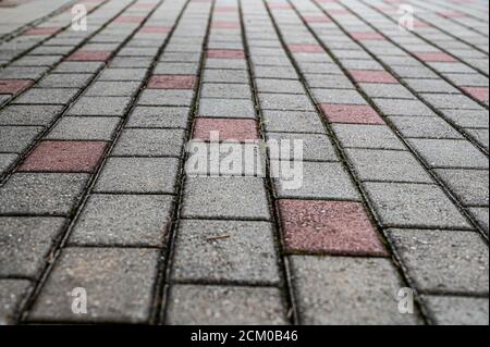 Perspective view of red and gray rectangular stones paved texture background. Stock Photo