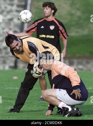 Chile S Cobreloa Coach Nelson Acosta R Picks Up A Cone Near Player Rodrigo Melendez Rear During A Training Session At The Cantera In Mexico City April 23 2003 Mexico S Pumas Will Play