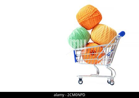 Trolley with yarn for knitting. Yarn for crocheting. Design of the embroidery section. Needlework. Hobbies and recreation. Colored threads on a white Stock Photo