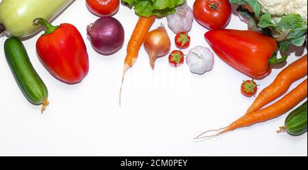 Vegetables layout on a white background . Home-grown vegetables. Harvest. Window dressing. Isolated vegetables. Article about vegetables. Agricultural Stock Photo