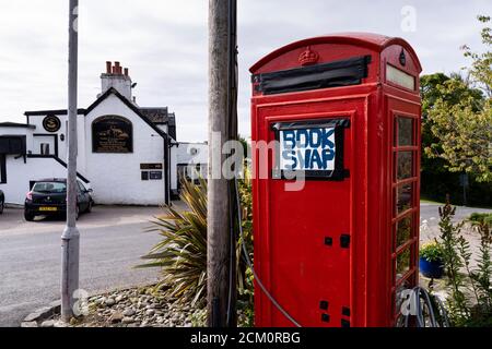 Ardfern village, Argyll. Book-swap in converted telephone booth. Stock Photo