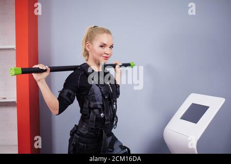 beautiful blond athlete with weight is looking at the camera in the sport club. close up side view photo Stock Photo