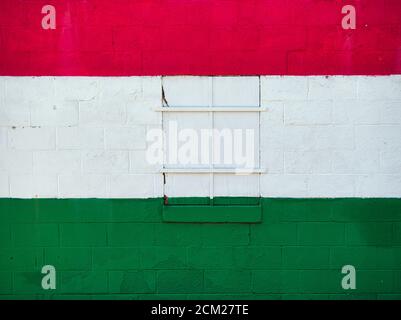 A white red and green painted shoe store wall and window. The store was owned by a Hungarian - American. Stock Photo