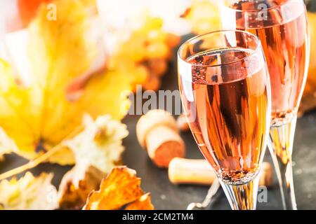 Rose pink champagne glasses and bottle, gray background, wine tasting concept, copy space Stock Photo