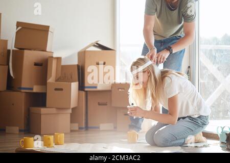 Portrait of happy caucsian couple planning new house design looking at paper Stock Photo