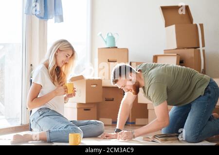 Portrait of happy caucsian couple planning new house design looking at paper Stock Photo