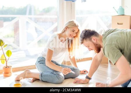 Portrait of happy caucsian couple planning new house design looking at paper Stock Photo