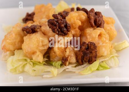 Detail view of appetizing plate tempting the tastebuds with Honey Walnut Shrimp in perfect serving size. Stock Photo