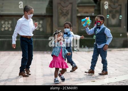 Manhattan, New York, USA. 16th Sep, 2020. Young children chase bubbles as they play at The Bethesda Terrace in Central Park while wearing PPE masks after taking part in an outdoor wedding in Manhattan, New York. Mandatory credit: Kostas Lymperopoulos/CSM/Alamy Live News Stock Photo