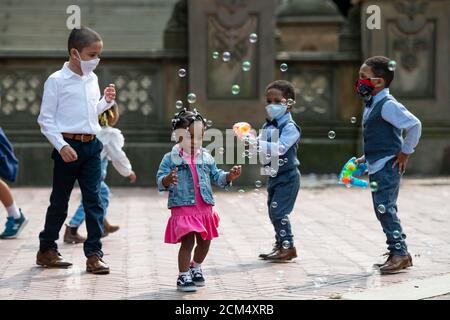 Manhattan, New York, USA. 16th Sep, 2020. Young children chase bubbles as they play at The Bethesda Terrace in Central Park while wearing PPE masks after taking part in an outdoor wedding in Manhattan, New York. Mandatory credit: Kostas Lymperopoulos/CSM/Alamy Live News Stock Photo