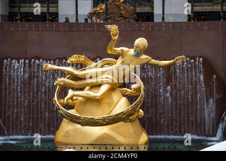 Manhattan, New York, USA. 16th Sep, 2020. The Prometheus sculpture in Rockefeller Center features a PPE mask due to Covid-19 in Manhattan, New York. Mandatory credit: Kostas Lymperopoulos/CSM/Alamy Live News Stock Photo