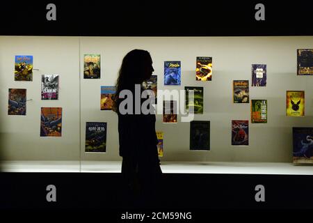 A gallery assistant poses for photographs during the press preview of the exhibition 'Harry Potter: A History of Magic' at the British Library in London, Britain, October 18, 2017. REUTERS/Mary Turner