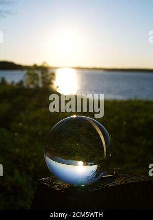 Reflection of Belmont Bay during sunset in glass orb Stock Photo