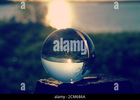 Reflection of Belmont Bay during sunset in glass orb Stock Photo